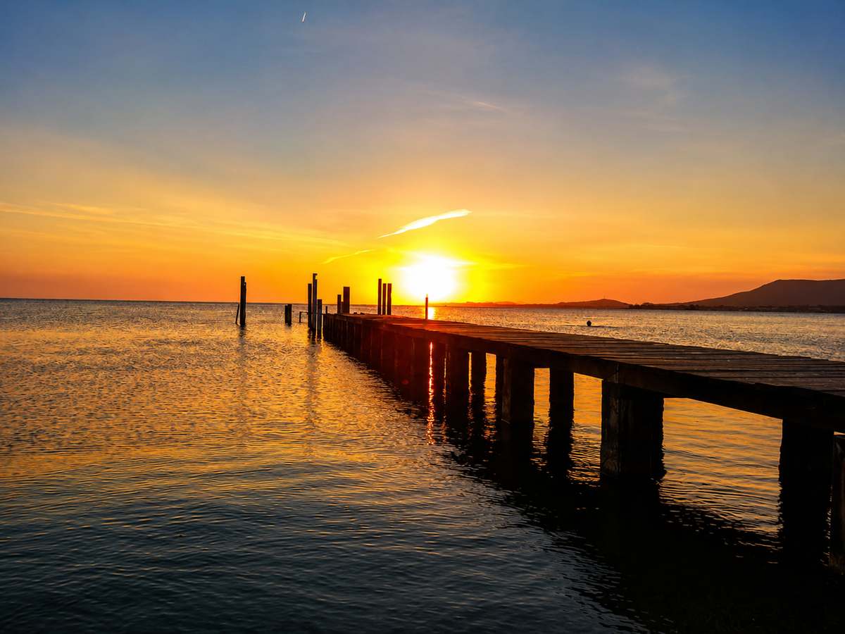 Sunset over the lagoon pier at São Pedro da Aldeia